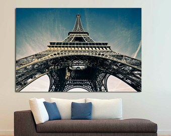 May include: A low angle view of the Eiffel Tower in Paris, France. The tower is made of metal and is a popular tourist destination.