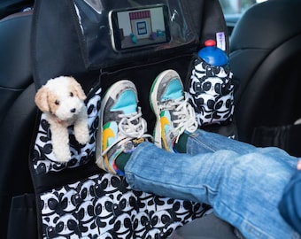 May include: Black car seat back organizer with a panda print. It has a clear pocket for a phone or tablet, a mesh pocket for a water bottle, and two side pockets for small items. A stuffed animal and a pair of shoes are in the pockets.