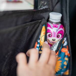 Travel organizer for kids - two pockets for baby bottles, one of which is thermally insulated.