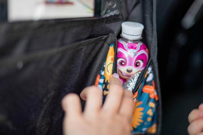 Travel organizer for kids - two pockets for baby bottles, one of which is thermally insulated.