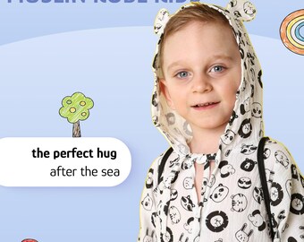 May include: A white muslin robe for children featuring a black and white animal print pattern, a hood with small ears, and long sleeves. The text on the image reads MUSLIN ROBE KIDS, the perfect hug after the sea, with cartoon drawings.