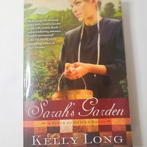 May include: Book cover for "Sarah's Garden" by Kelly Long. The cover features a woman holding a basket, with a background of trees. The title is in elegant script, and the author's name is at the bottom.