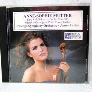 May include: A CD case featuring Anne-Sophie Mutter, with text indicating a Berg violin concerto performed by the Chicago Symphony Orchestra. The cover art shows Mutter holding a violin, with the Musical Heritage Society logo.