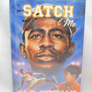 May include: A book cover with a portrait of a man wearing a baseball cap, with the title "Satch & Me" in large yellow letters. The cover also features illustrations of baseball players and the author's name, Dan Gutman.