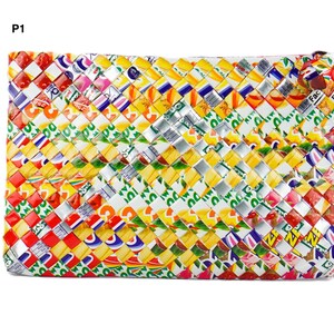 May include: A rectangular clutch made from woven recycled materials. The clutch features a colorful pattern of red, yellow, silver, and white, with text visible on the woven strips. The clutch has a zipper closure.