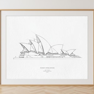 May include: Framed black and white architectural print of the Sydney Opera House. The artwork features a detailed line drawing of the iconic building, with the text "SYDNEY OPERA HOUSE" and location details.