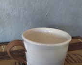 Mug with white glaze accented in unglazed borders