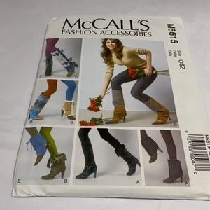 May include: A McCall's M6615 sewing pattern envelope for fashion accessories, specifically boot covers and leg warmers. The white paper envelope features multiple photographs showing various styles of leg coverings in different colors and textures.