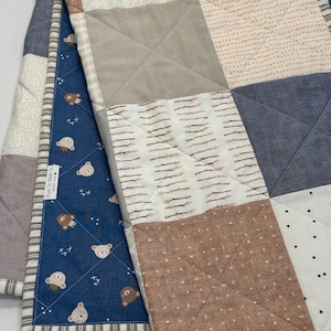 May include: A white ceramic mug with a black handle and the text "But First, Coffee" in a black, handwritten-style font. The mug is on a white surface.