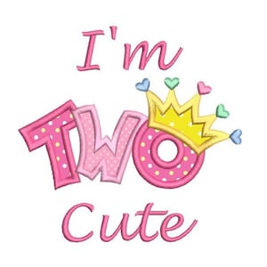 May include: Pink and yellow embroidered design with the text "I'm Two Cute" and a crown with hearts.