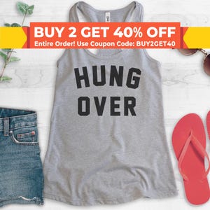 May include: Gray tank top with the text "HUNG OVER" in black letters. The tank top is on a white wooden surface.