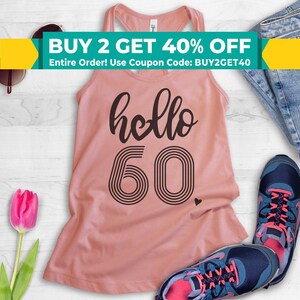 May include: A pink tank top with the text "hello 60" in black. The number 60 is in a retro style font with black stripes. The text "BUY 2 GET 40% OFF Entire Order! Use Coupon Code: BUY2GET40" is at the top of the image.
