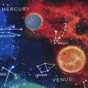 May include: Fabric with a colorful space-themed design. The fabric features planets, constellations, and the names of planets like Mercury and Venus. The background is a mix of blue, red, and orange hues, with white stars scattered throughout.