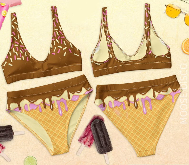 May include: A brown and white swimsuit with a chocolate and ice cream cone print. The top is a scoop neck with thin straps and the bottom is a high-waisted bikini bottom.