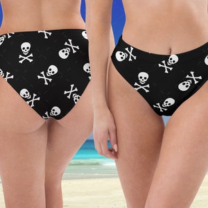 May include: Black bikini bottoms with a white skull and crossbones pattern.