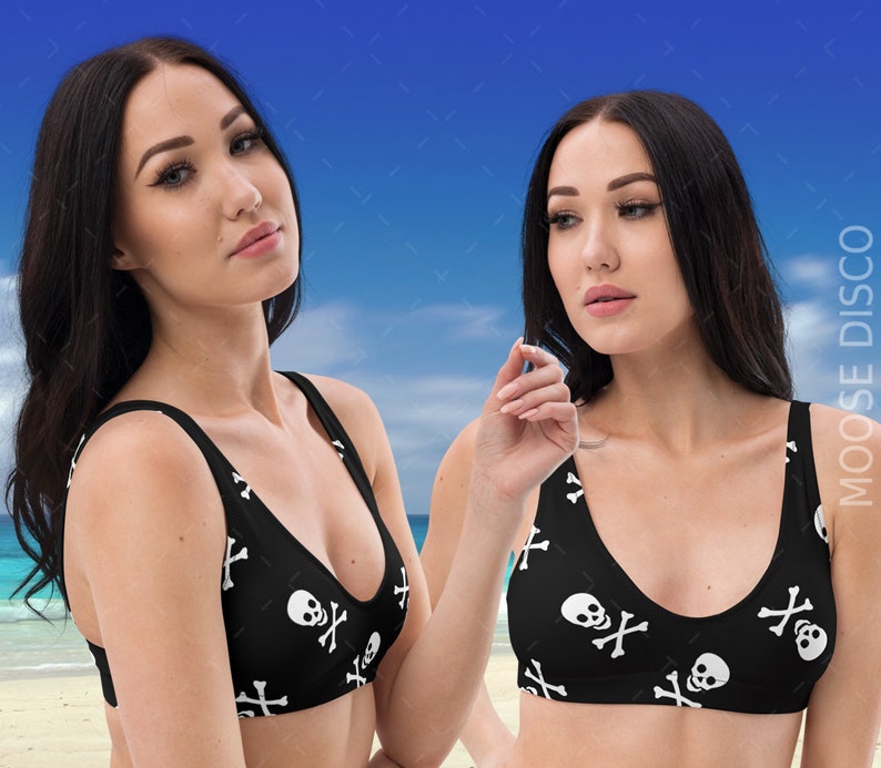 May include: Two black bikini tops with a white skull and crossbones pattern. The tops have a scoop neck and adjustable straps.