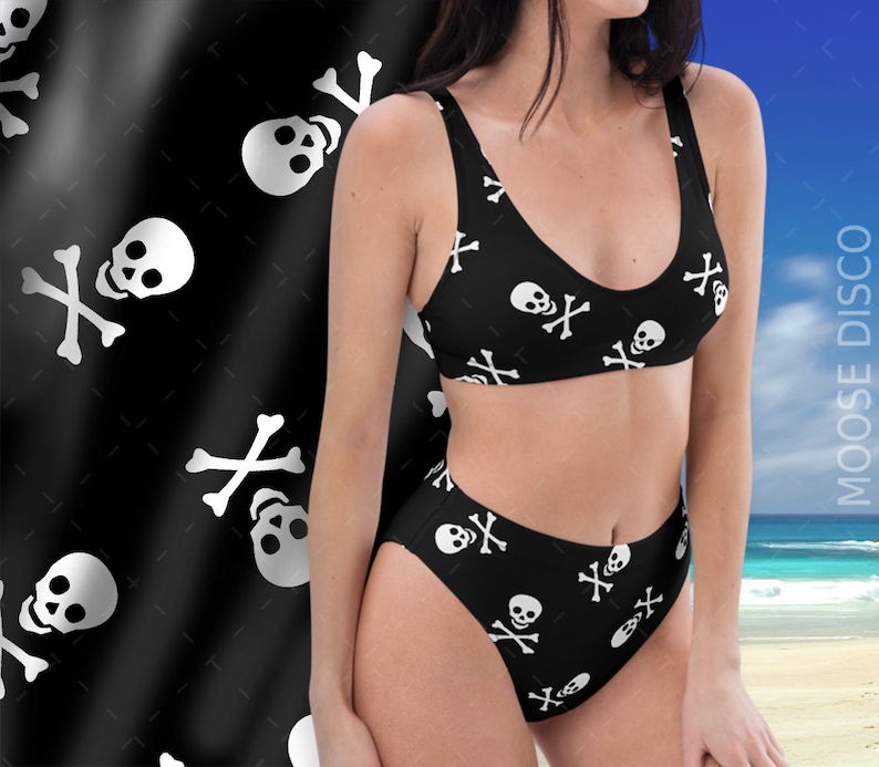 May include: Black and white high-waisted bikini with a skull and crossbones pattern. The bikini top and bottom have a scoop neck and a high-cut leg.