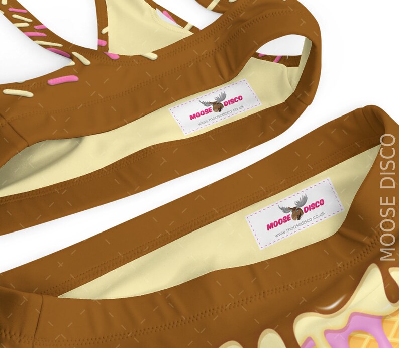 May include: Brown and white swimsuit with pink and white trim. The swimsuit has a moose logo with the text "MOOSE DISCO" and the website "www.moosedisco.co.uk".