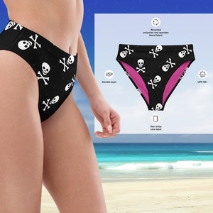 May include: Black high-waisted swimsuit bottom with a white skull and crossbones pattern. The swimsuit is double-layered and made from recycled polyester and spandex blend fabric. The fabric has a UPF 50+ rating.