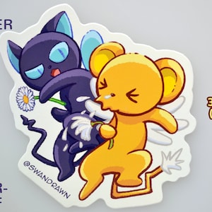 May include: A waterproof vinyl sticker featuring two cartoon characters. One is a dark purple cat-like creature holding a daisy, and the other is a yellow mouse-like character. The sticker is 3.15 inches (8 cm) tall and has the text "VINYL STICKER".