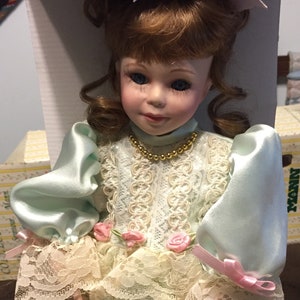 1995 Seymour Mann 16” Connoisseur Collection Doll w/Stand #CD-16634B. COA Beautiful mint green satin short dress with pantaloons