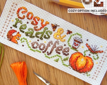 May include: Cross stitch pattern featuring the text "Cozy Reads & Coffee" with a pumpkin, a cup of coffee, a squirrel, and a book. Cozy option included.