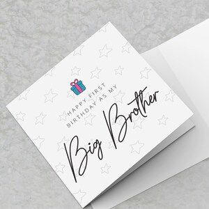 May include: A white card with a white star pattern and the text "HAPPY FIRST BIRTHDAY AS MY Big Brother". The card has a small blue and pink gift box icon. The card is folded in half and the inside of the card is blank.