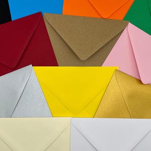 a group of different colored envelopes sitting next to each other