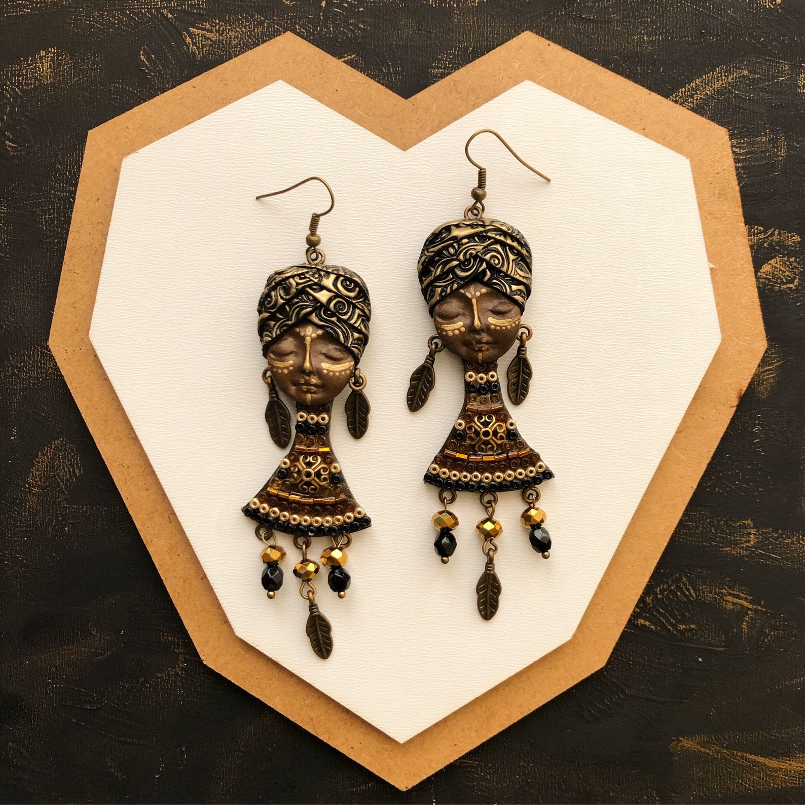 Big African face earrings made by polymer clay. Golden Etsy