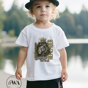 May include: A white t-shirt with a graphic of a lion wearing a crown and the text "Remember who you are".