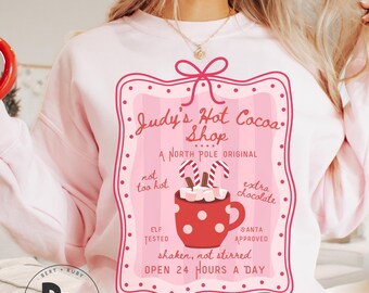 Judy's Hot Cocoa Shop A North Pole Original Coquette Adult Gildan Unisex Crewneck Sweatshirt (AS18)