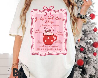 Judy's Hot Cocoa Shop Coquette A North Pole Original Comfort Colors™ Adult Unisex T-Shirt (ACCT18)