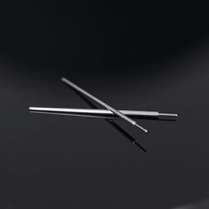 May include: Two silver metal tools with pointed tips are crossed against a dark background. One tool has a small, rounded tip. The tools appear to be precision instruments, possibly for crafting or technical work.