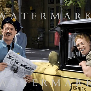 May include: Two men in a vintage setting. One man is wearing a blue uniform and holding a newspaper with the headline "Smith Wins Nomination!" The other man is sitting in a yellow car with the word "ERNIE'S" on the side.