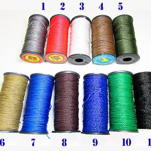May include: Eleven spools of waxed thread in various colors, including gray, red, white, brown, green, gold, blue, black, and dark brown. The spools are numbered 1 through 11.