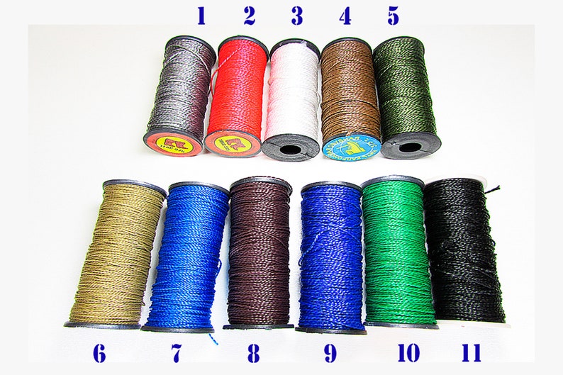 May include: Eleven spools of waxed thread in various colors, including gray, red, white, brown, green, gold, blue, black, and dark brown. The spools are numbered 1 through 11.