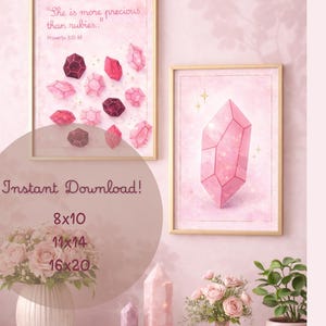 May include: Two framed art prints with gold frames. One features pink crystals and the text "She is more precious than rubies." The other print displays a large pink crystal. A vase of flowers and decorative crystals are in the foreground.