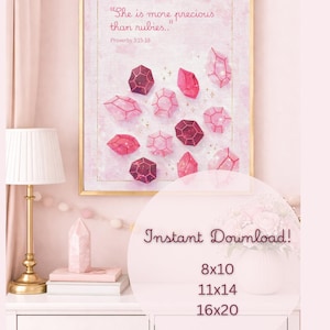 May include: A framed print with a gold frame featuring a watercolor illustration of pink and red crystals. The text "She is more precious than rubies.." and "Proverbs 3:15-18" are displayed. The words "Instant Download!" and sizes are also visible.