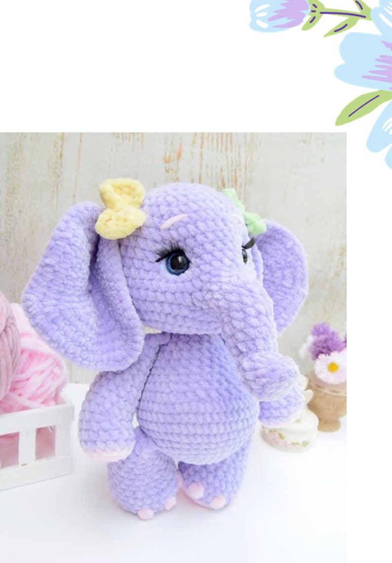 May include: A crocheted purple elephant plush toy with yellow and green bows. The elephant has blue eyes and pink feet.