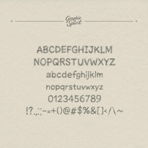 May include: A full alphabet and number set in a sketched font style. The uppercase and lowercase letters, numbers, and symbols are displayed in a grey colour against a beige textured background. The text "Graphic Spirit" is at the top.