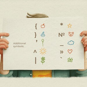 May include: A person holding a white paper with colourful illustrations of symbols and the text "Additional symbols:". The symbols include an apple, sailboat, balloon, sun, flower, star, teddy bear, cloud, heart, and butterfly.