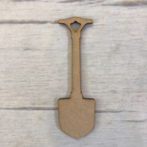 May include: A wooden cutout of a shovel with a brown finish. The shovel has a handle with a decorative top.