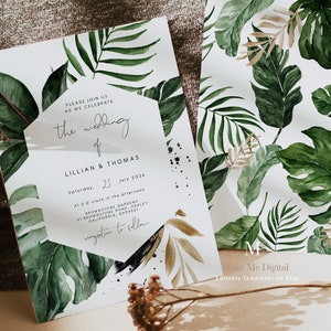 May include: A wedding invitation with a tropical theme. The invitation is printed on white cardstock with a green and gold watercolour design of tropical leaves. The text on the invitation reads "Please join us as we celebrate the wedding of Lillian & Thomas, Saturday, 23 July 2024, At 3 O'clock in the afternoon, Brownstone Gardens, 91 Brownstone Road, Oakley, California, CA 94561, Reception to follow". The invitation is also decorated with black paint splatters.