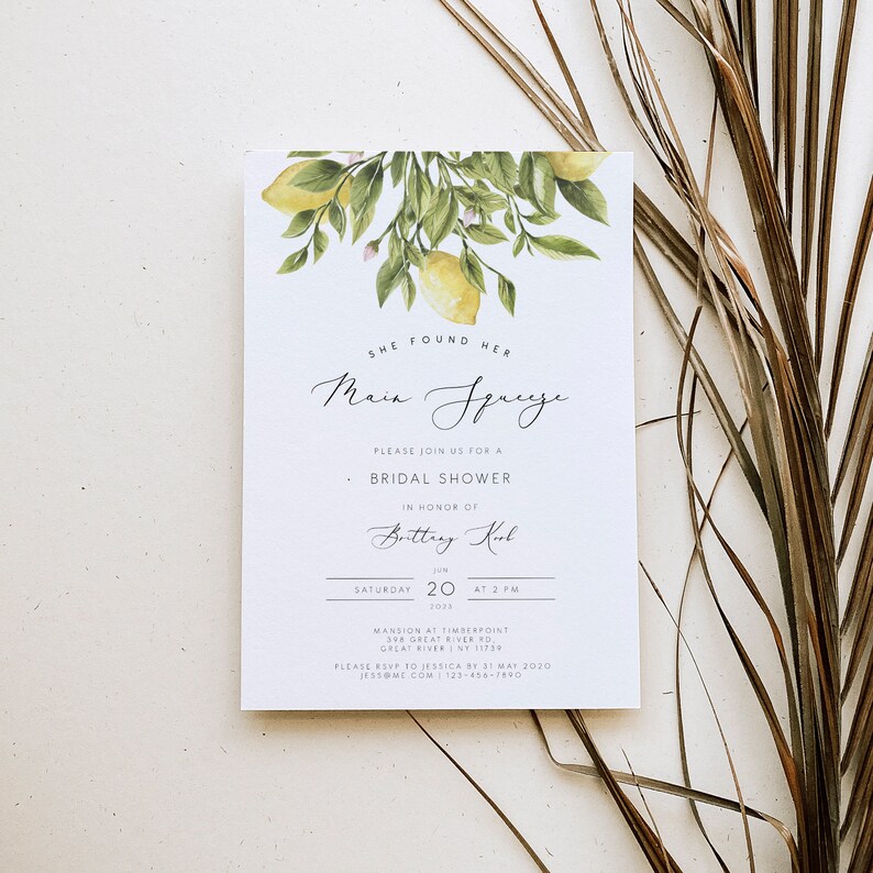 May include: A white bridal shower invitation with a watercolor illustration of lemons and leaves. The text reads "She found her Main Squeeze" and includes the bride's name, date, time, and location.