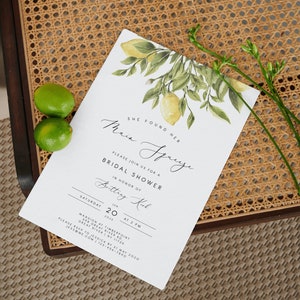 May include: A white bridal shower invitation with a lemon branch illustration. The invitation reads "She found her Main Squeeze" and includes the details for a bridal shower for Brittey Kirl on June 20, 2023 at 2 PM at the Mansion at Timberpoint, 398 Great River Rd, Great River, NY 11739. RSVP by May 31, 2020 to Jessica at jess@me.com or 123-456-7890.