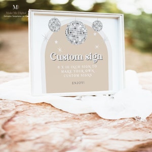Puede incluir: Un marco blanco con un fondo beige y un cartel que dice "Custom sign 8 x 10 inch sign to make your own custom signs Enjoy!" El cartel est&aacute; decorado con bolas de discoteca plateadas y estrellas.