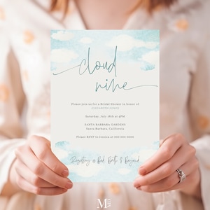 May include: A blue and white watercolor invitation with the text "cloud nine" in teal script. The invitation is for a bridal shower in honor of Elizabeth Jones. The event will be held on Saturday, July 16th at 4 PM at Santa Barbara Gardens in Santa Barbara, California. The RSVP information is included, along with the registry information at Bed, Bath & Beyond. The invitation is from Make Me Digital, which is an Etsy shop that sells editable templates.