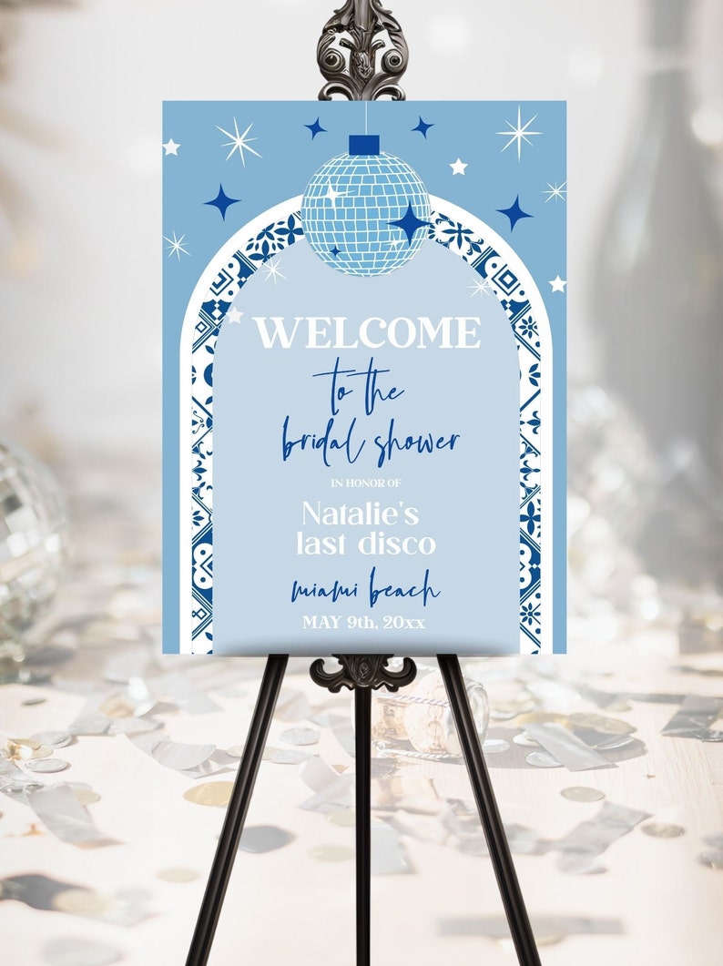 May include: Blue and white welcome sign for a bridal shower with a disco ball and stars. The text reads "Welcome to the bridal shower in honor of Natalie's last disco Miami Beach May 9th, 20xx".