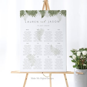 May include: A wedding seating chart with a green fern design. The chart lists the names of guests for each table, with the tables numbered one through eleven. The chart is titled "Lauren and Jason" and the date "13 July 2020".