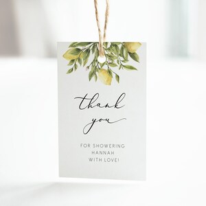 May include: A white thank you tag with a watercolor illustration of lemons and leaves. The text reads "thank you" in cursive and "for showering Hannah with love!"